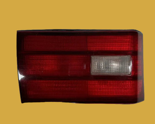 Red and clear car tail light on a white background