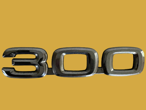 Metallic '300' emblem on a light background